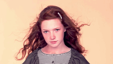 a quick burst of photos a young redhaired woman in various poses, created with animoto